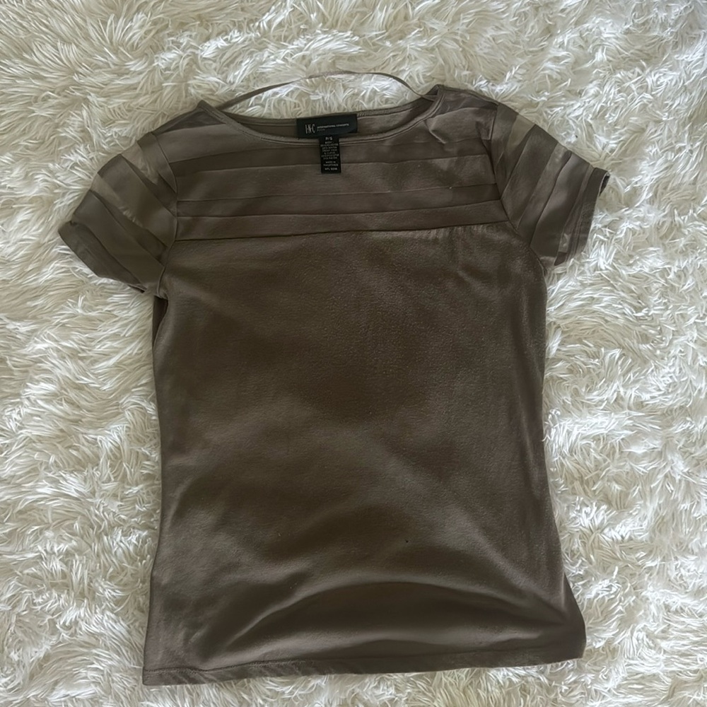 Green top with see through shoulders and neckline.